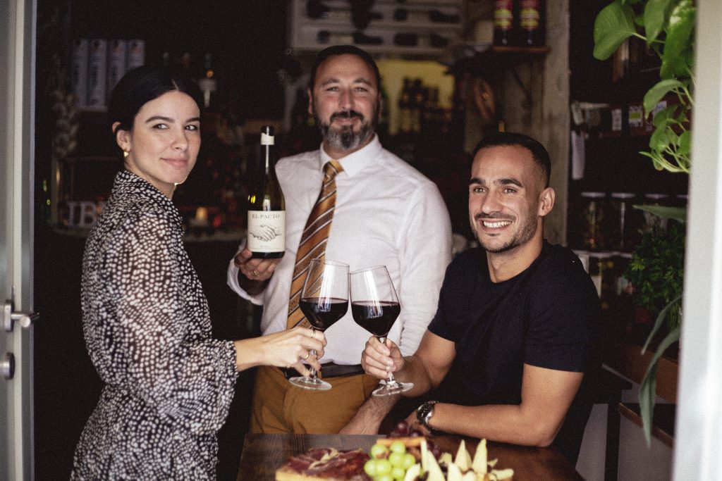 Guests enjoying tapas and wine at Iber&Cos outdoor terrace