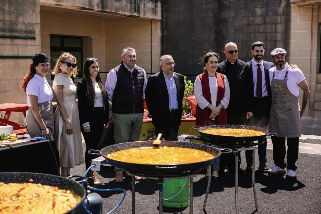Iber&Co team teaching students how to make paella at St Thomas More College in Malta
