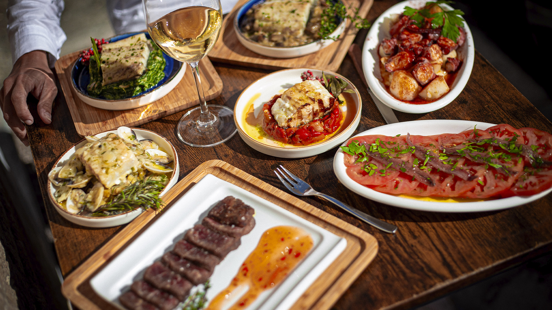 Friends sharing authentic Spanish tapas at Iber&Co in Valletta