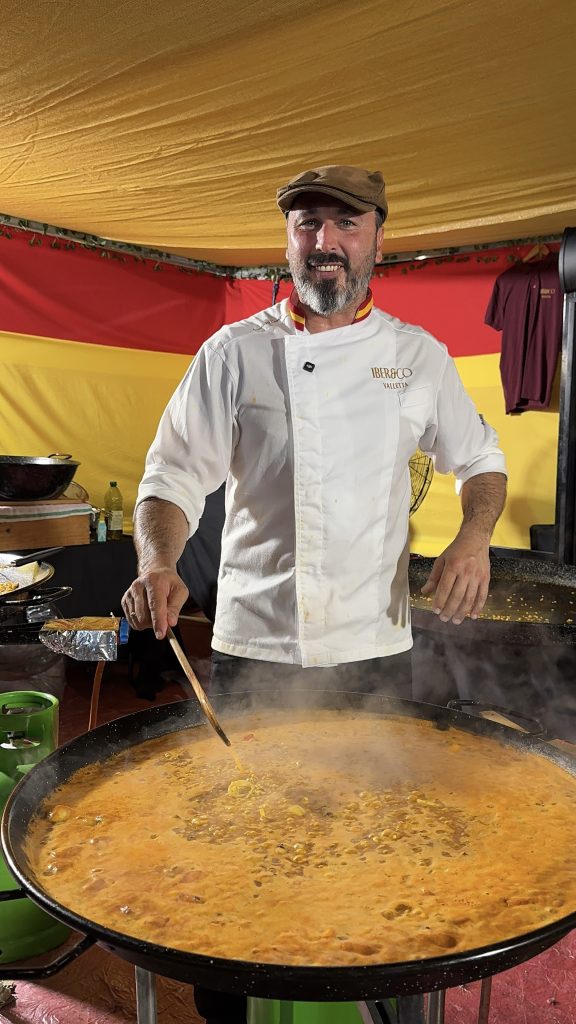 ALT: Large Iber&Co y Altamira double stand at Malta International Food Festival with guests ordering Spanish food